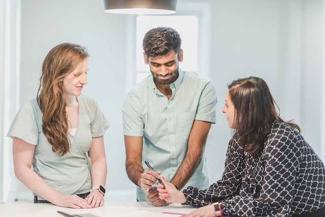 Three people looking over a document together